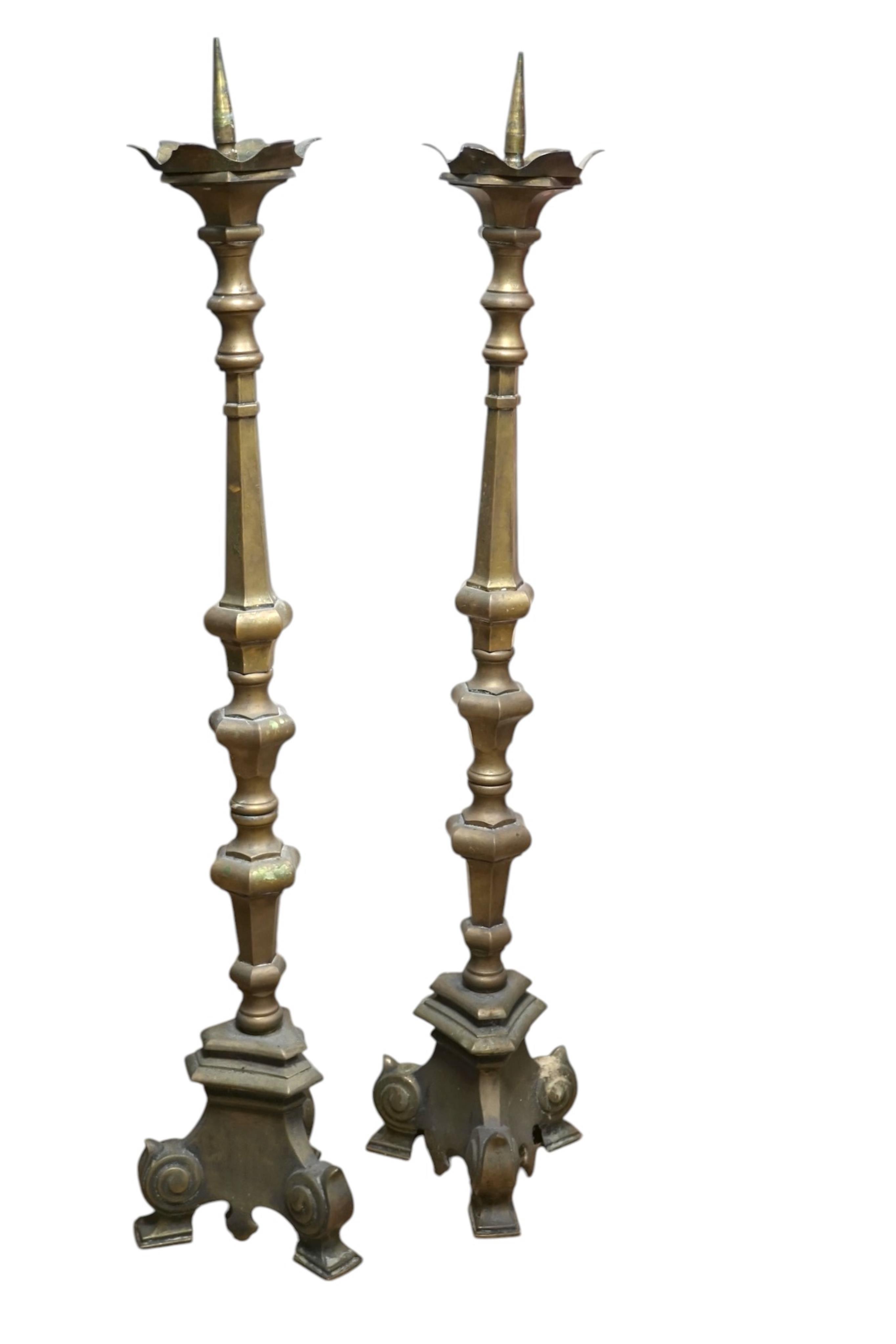 A pair of large Dutch altar brass candle sticks, 113cm high. Condition - fair to good